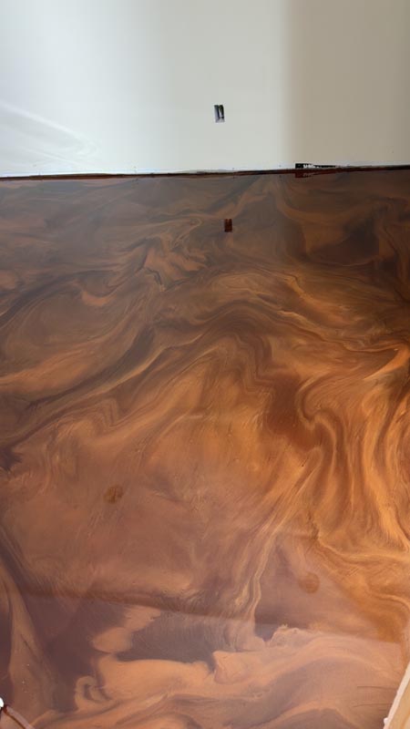 Close-up of copper and brown metallic epoxy swirl finish