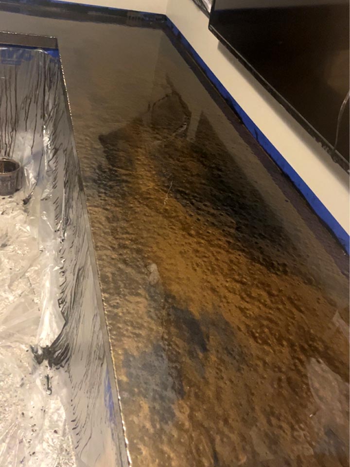Metallic epoxy floor with copper and black swirl finish