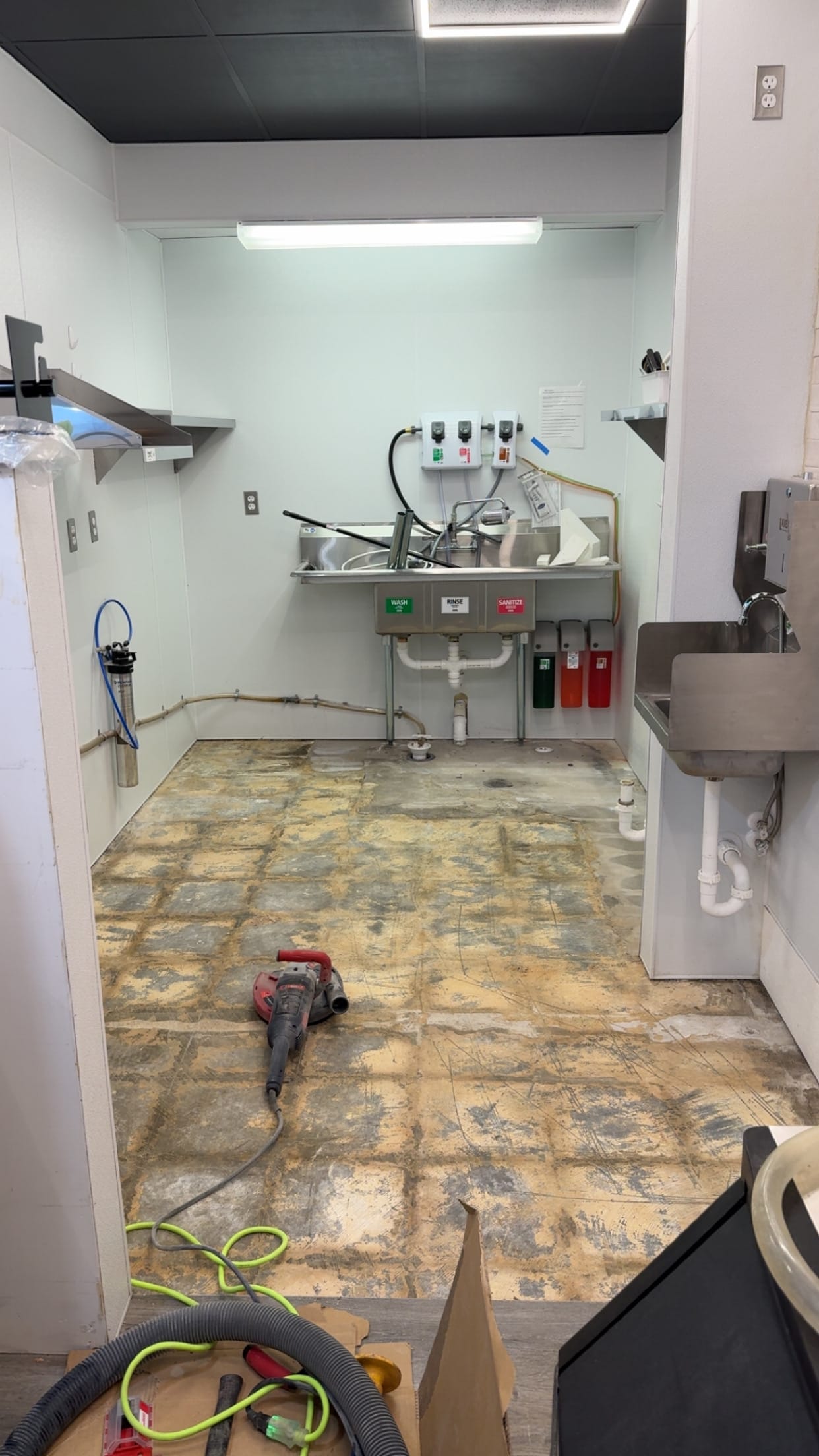 Commercial kitchen floor with old tile and thinset ground off
