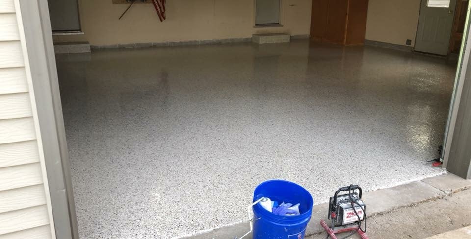 Residential garage after, finished glossy grey flake floor