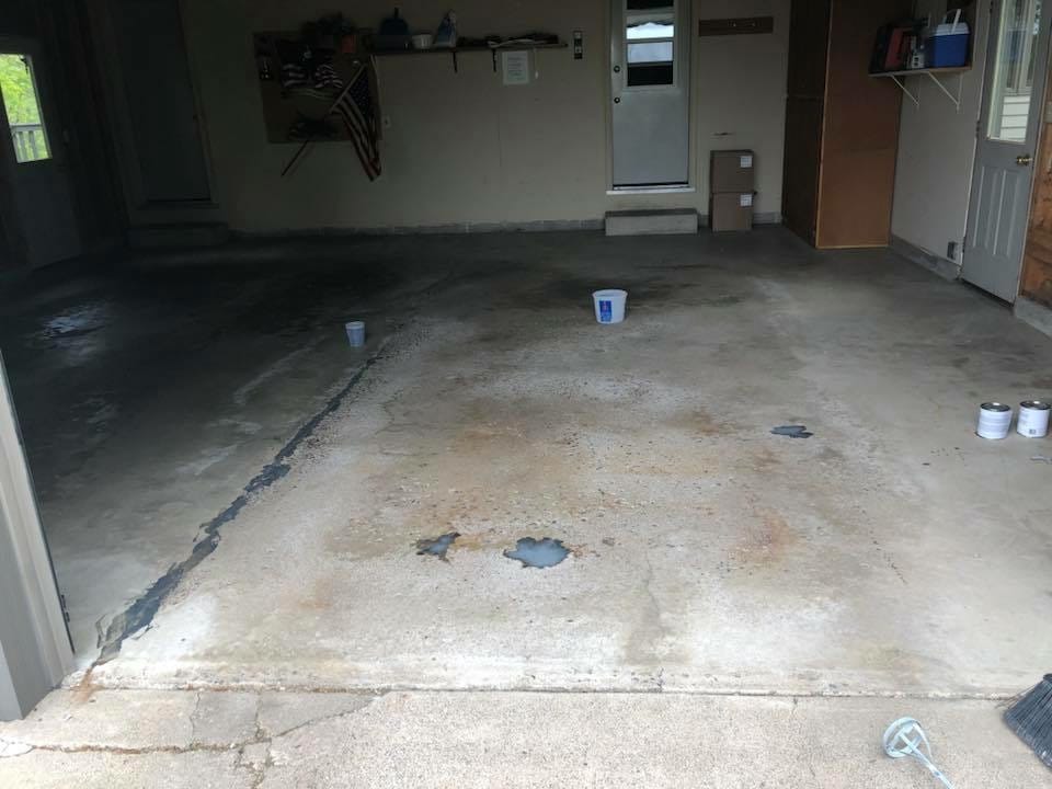 Residential garage before, bare cracked and stained concrete floor