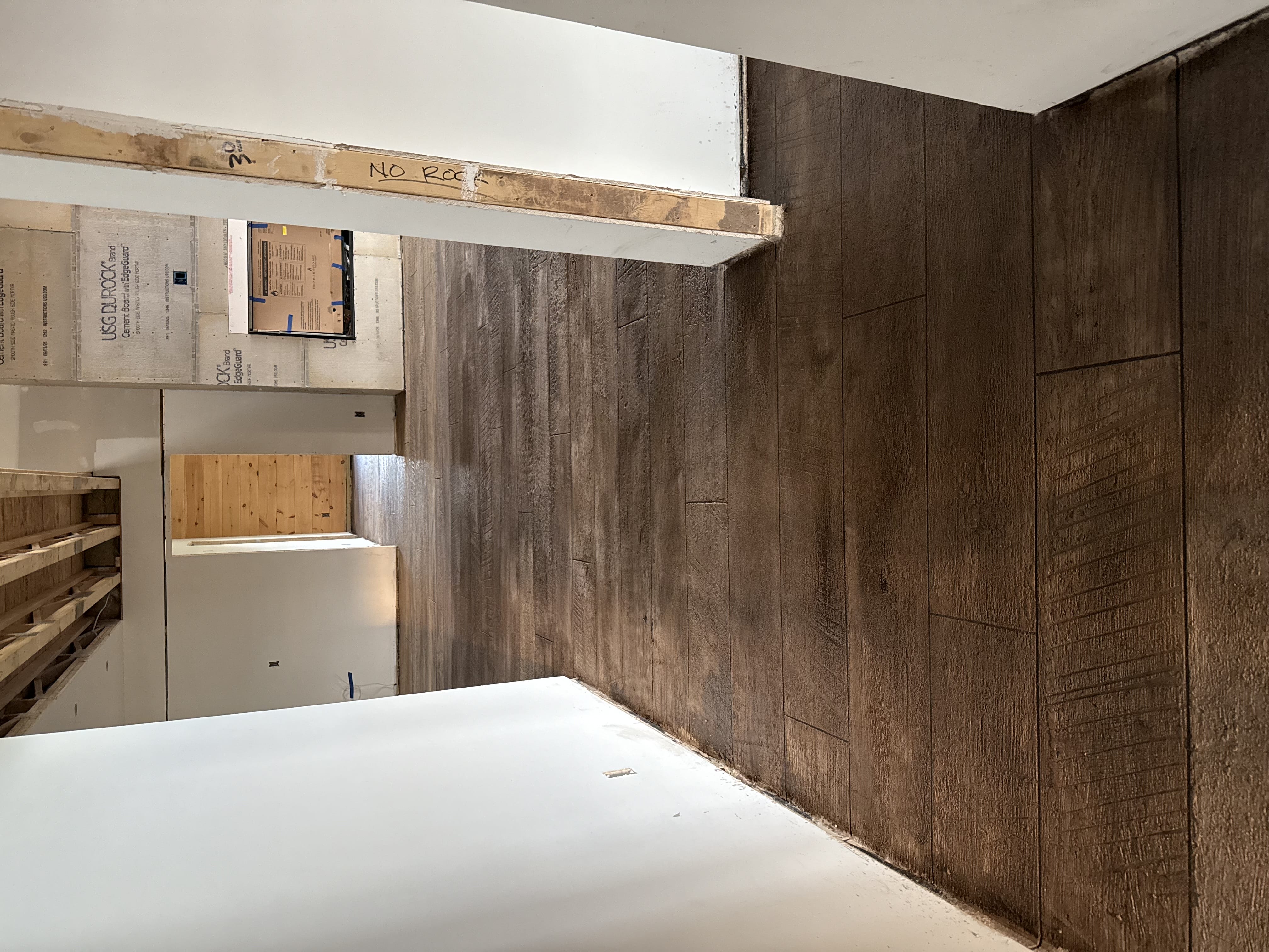 Hallway with brown wood-plank stained stamped concrete floor